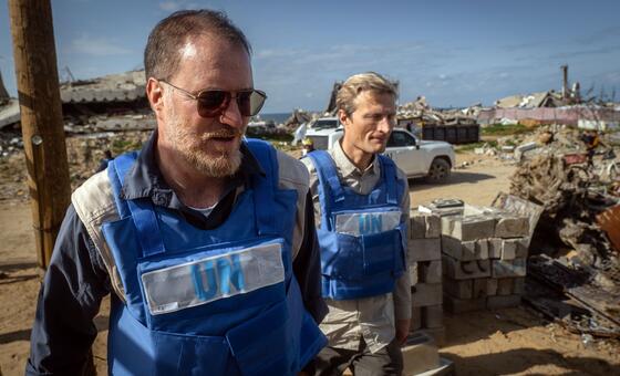 Shaun Hughes (left), WFP Country Director for Palestine, walks amid massive destruction in Gaza.